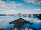 Lake with a small island and mountains in the background